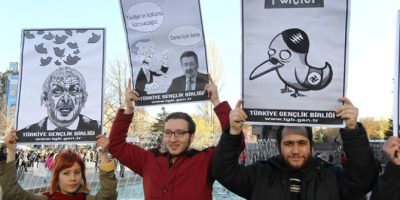 People in Turkey hold placards as they protest against Turkey's Prime Minister after the government of Turkey blocked access to Microblogging platformTwitter